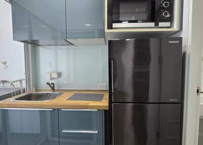 Modern kitchen with grey cabinets and wooden countertops