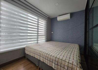 Modern bedroom with large window and air conditioning