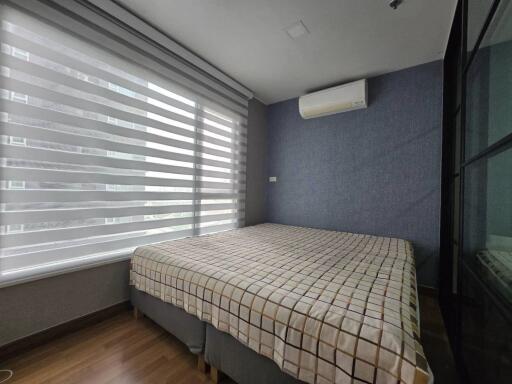 Modern bedroom with large window and air conditioning