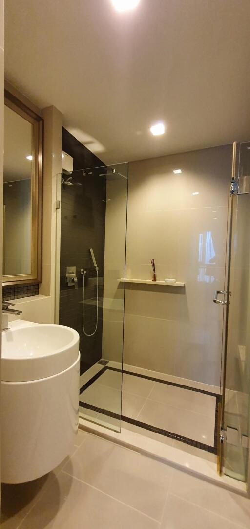 Modern bathroom with glass shower enclosure and vanity sink