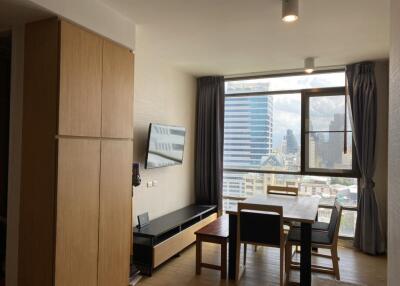 Modern living room with a dining area and city view