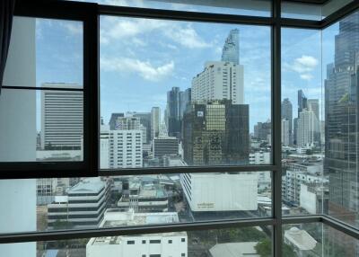 City skyline view from a high-rise apartment window