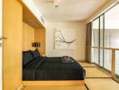 Modern bedroom with a large bed and sliding glass door to a balcony