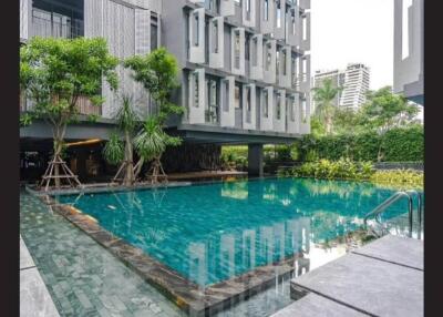 Modern building with swimming pool and greenery