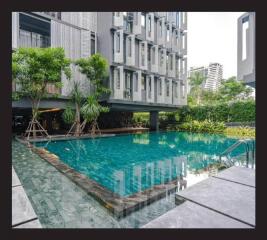 Modern building with swimming pool and greenery