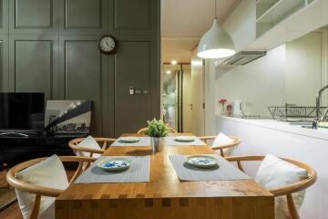 Modern dining area with wooden table, chairs, and decorative features