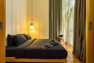 Bedroom with cozy lighting and floor-to-ceiling windows