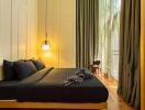 Bedroom with cozy lighting and floor-to-ceiling windows