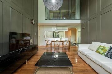 Modern living room with high ceilings and contemporary furnishings