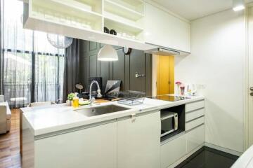 Modern kitchen with white countertops and open shelving