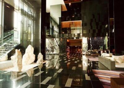 Modern building lobby with reflective surfaces and artistic decor