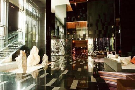 Modern building lobby with reflective surfaces and artistic decor