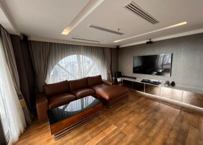 Modern living room with large sofa and TV