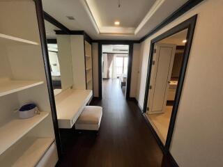 Spacious hallway with built-in shelving and vanity