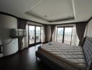 Spacious bedroom with large windows and city view