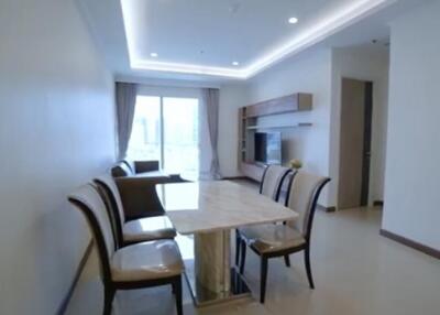 Modern living and dining area with table, chairs, sofa, and TV