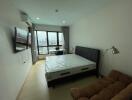 Spacious bedroom with large window and city view