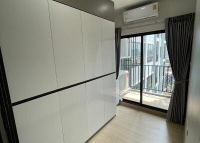 Modern bedroom with built-in wardrobe and balcony access