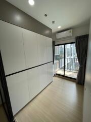 Modern bedroom with built-in wardrobe and balcony access