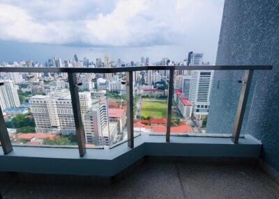 A balcony with a panoramic view of the city skyline