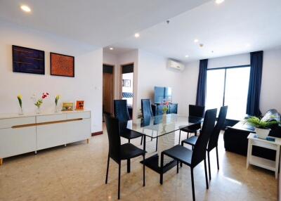 Modern dining area with glass table and black chairs in open living space