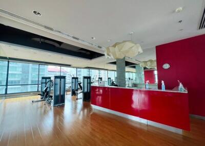 Spacious gym area with modern equipment and large windows