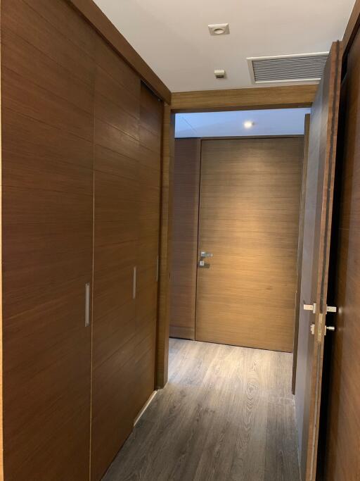 Modern hallway with wooden doors and flooring