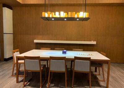 Modern dining area with wooden furniture and contemporary chandelier