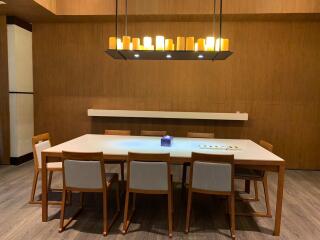 Modern dining area with wooden furniture and contemporary chandelier