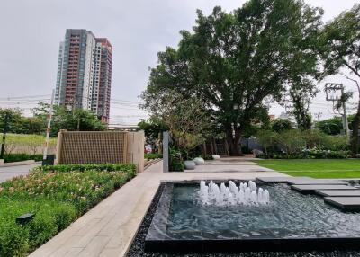 Modern residential complex with landscaped garden and fountain