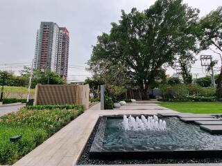 Modern residential complex with landscaped garden and fountain