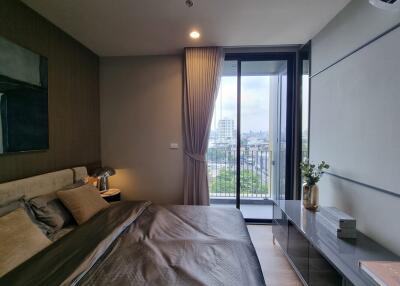 Master bedroom with large window and city view