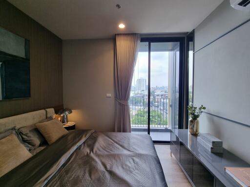 Master bedroom with large window and city view