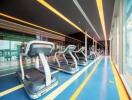 Modern gym with treadmills and large windows