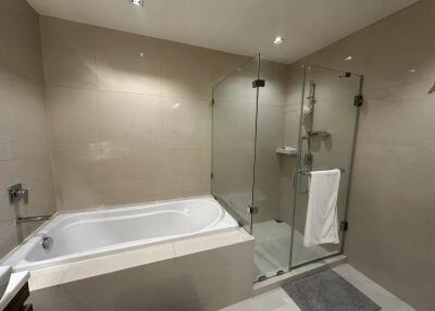 Modern bathroom with bathtub and glass-enclosed shower