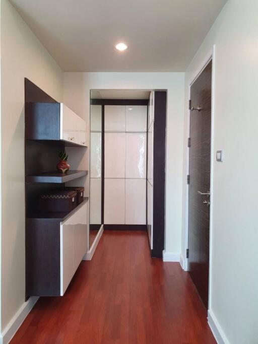 Modern hallway with storage cabinets and wooden flooring