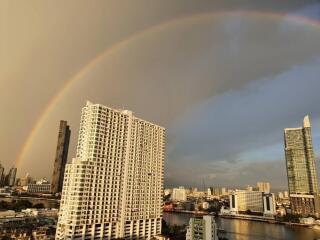 View of a cityscape with a rainbow