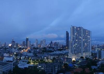 City skyline at dusk with high-rise buildings