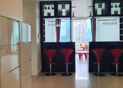 Modern kitchen with bar stools and hanging wine glasses