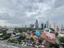 view of cityscape with roads and buildings on a cloudy day