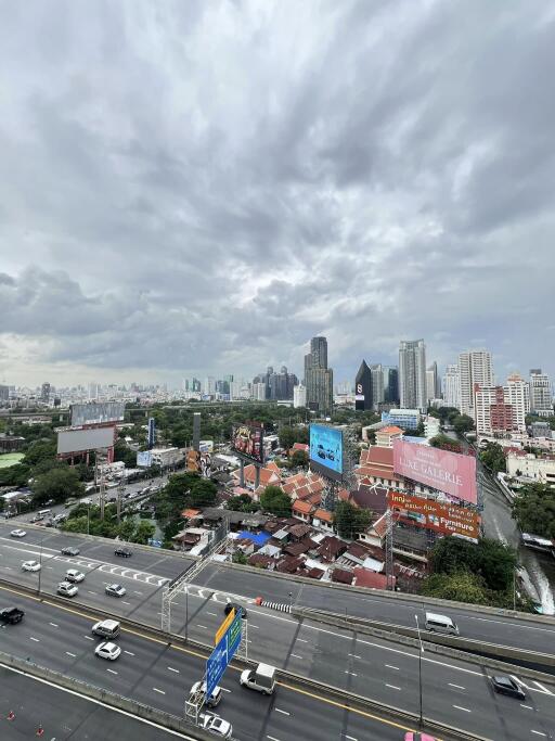 view of cityscape with roads and buildings on a cloudy day