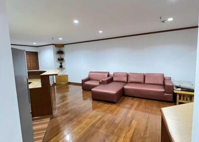 Living room with seating area and wooden flooring