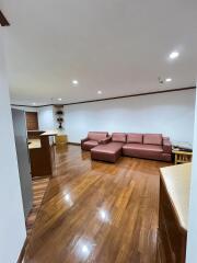 Living room with seating area and wooden flooring