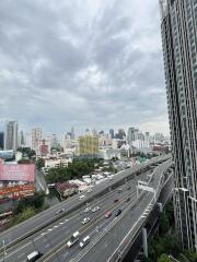 View of cityscape with high-rise buildings and highway