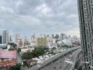 View of cityscape with high-rise buildings and highway