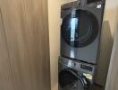 Laundry area with stacked washer and dryer