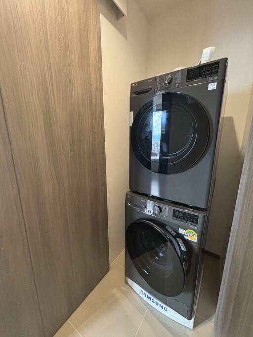 Laundry area with stacked washer and dryer