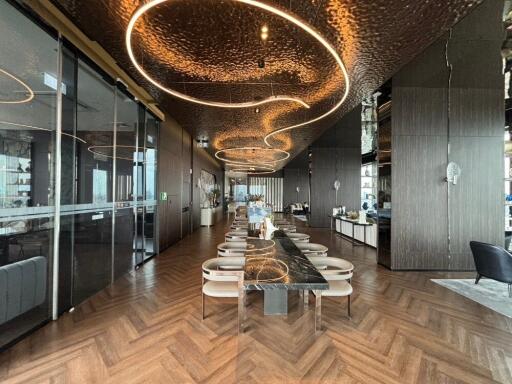 Modern dining area with stylish lighting and long table