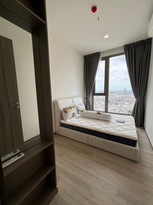 Modern bedroom with large window and view