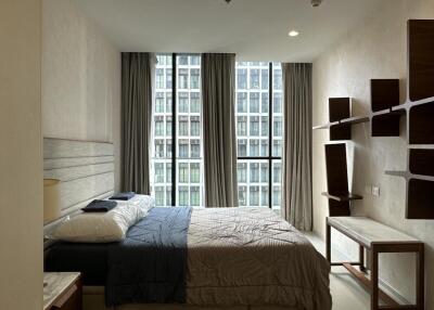 Modern apartment bedroom with large windows and contemporary furniture